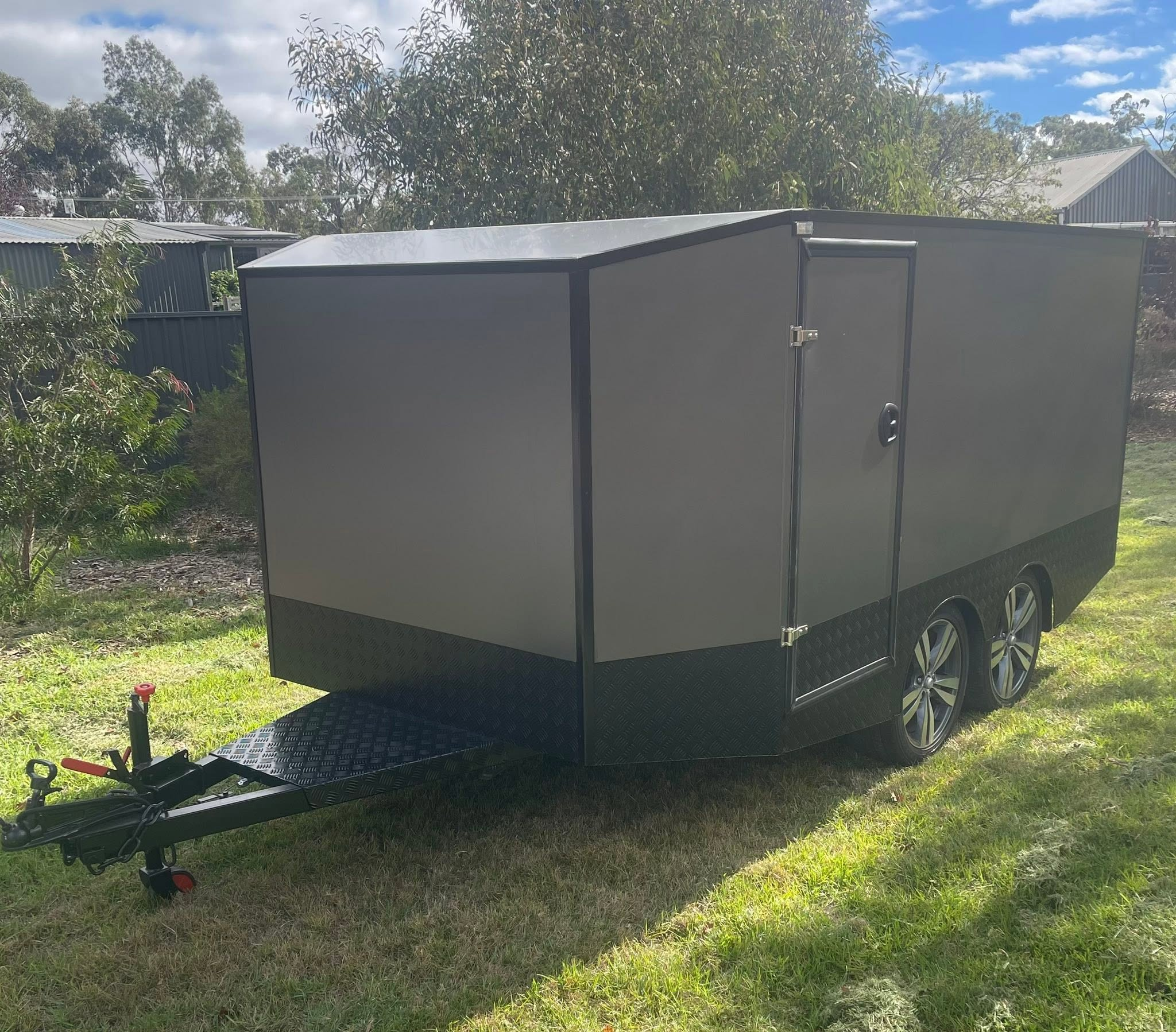 Grey tandem custom toy hauler with side access door